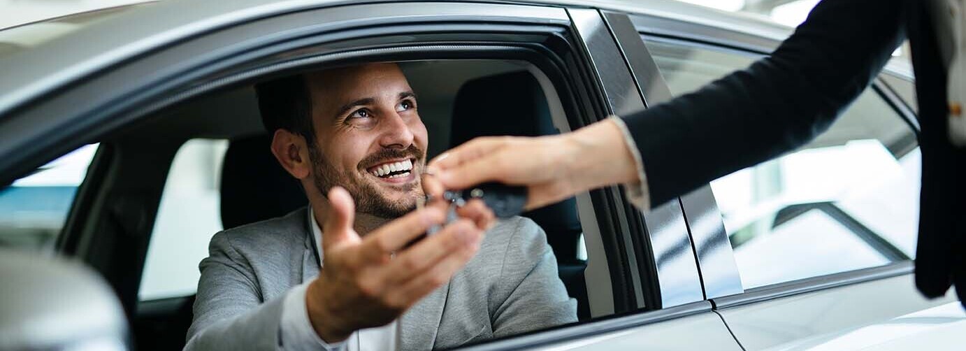 Person in vehicle being handed a key.