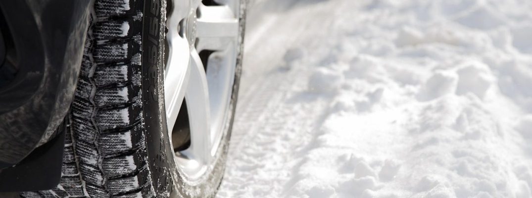 A car drives along snow.